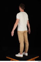  Trent brown trousers casual dressed standing white sneakers white t shirt whole body 0004.jpg